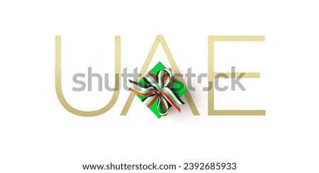 A green color gift pack with 'UAE' typography watermark on white background. Conceptual typography for United Arab Emirates national day celebration.
