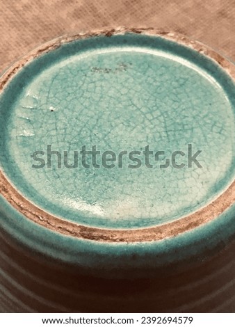 Vintage Old Pottery with Green Celadon Glass and Age Glaze Crazing Royalty-Free Stock Photo #2392694579