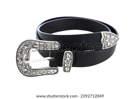 Black women's western belt with silver buckle with floral motifs isolated on white background.