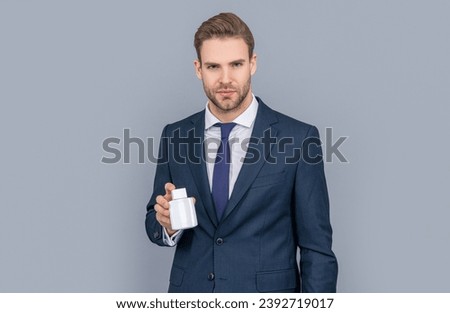 Antidepressant and painkiller for business man. Businessman presenting pill jar. CEO offer painkiller. Businessman promoting medicine pill. Healthcare business. Promoting antibiotic