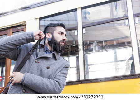 young hipster chases a tram