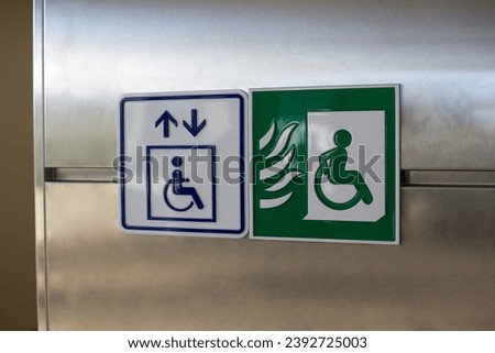 Green wheelchair sign with a person driving away from a fire. Symbol of a fireproof elevator in a building for disabled people