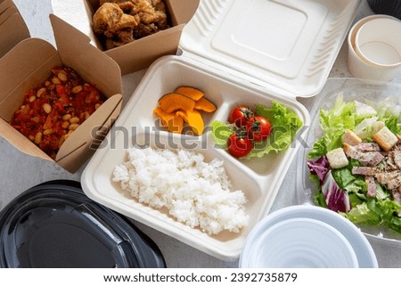 Doggy bags, lunch boxes, and a wide variety of dishes Royalty-Free Stock Photo #2392735879