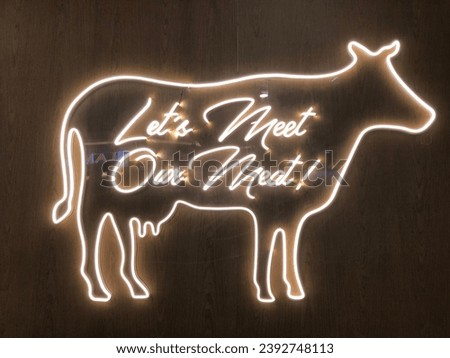 Neon yellow sign, lets meet our meat