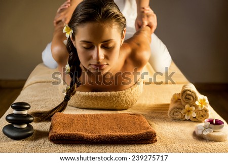 The beautiful girl has massage. Stretching. Thai massage. Royalty-Free Stock Photo #239275717