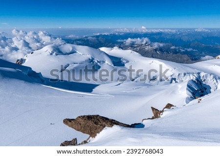 Switzerland, Panoramic view on Snow Alps and Blue Sky around Titlis mountain. Monte rosa or Dufourspitze Royalty-Free Stock Photo #2392768043