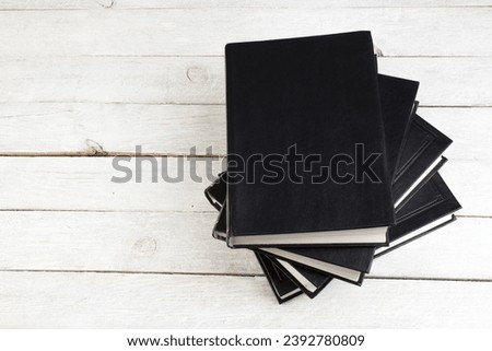 Open book on wooden deck table and black board background. Back to School. Education concept with copy space for your ad text