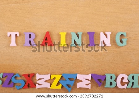 TRAINING word on wooden background composed from colorful abc alphabet block wooden letters, copy space for ad text. Learning english concept