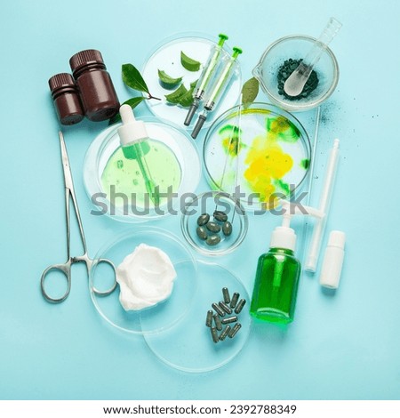 Cosmetic laboratory research on blue background. Beauty concept.