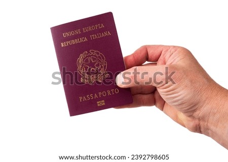 view of the hand holding out the Italian passport. isolated white background