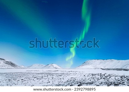 Aurora Borealis. Northern lights and starry skies. Nature. Scandinavian countries. Snow and ice on the mountains. Landscape in winter time. Photo for background and wallpaper.
