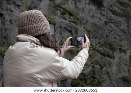 A young woman taking picture on a smartphone