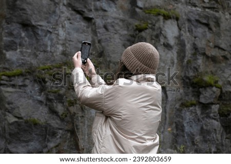A young woman taking picture on a smartphone