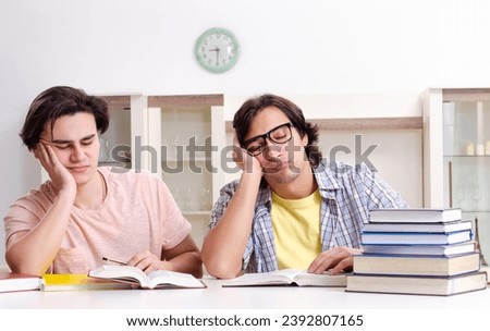 Two male students preparing for exams at home Royalty-Free Stock Photo #2392807165