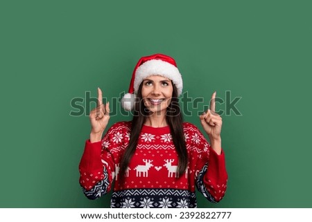 Photo of shiny dreamy lady santa helper dressed print xmas sweater showing two fingers up empty space isolated green color background