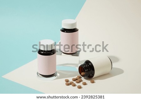 The brown pill was poured from an unlabeled pill bottle. One medicine bottle is placed on a glass platform and the other is placed on a petri dish. Minimalist space for advertising. Royalty-Free Stock Photo #2392825381