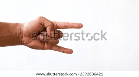 Male hand close-up on a white background shows hand gesture. Rock'n'roll. Isolate. Royalty-Free Stock Photo #2392836421