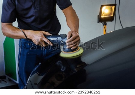 Car detailing.Man hand holding and polish the car. Royalty-Free Stock Photo #2392840261