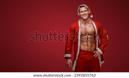 Cheerful fitness Santa smiling with a jacket over his shoulder