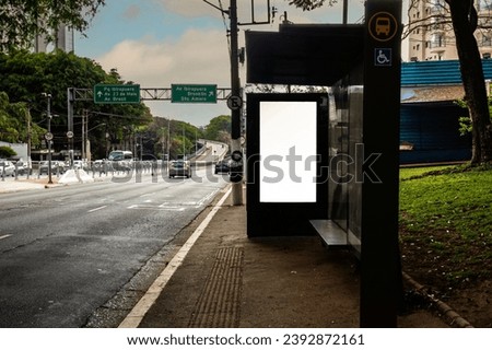 Digital Media blank advertising billboard in the bus stop  at avenue of Sao Paulo city. Blank billboards public commercial with passengers, signboard for product advertisement design Royalty-Free Stock Photo #2392872161
