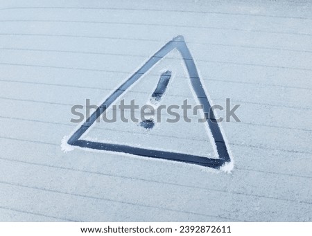 Winter Driving - Caution!

A warning triangle drawn in the ice on a frozen rear window of a car. Royalty-Free Stock Photo #2392872611