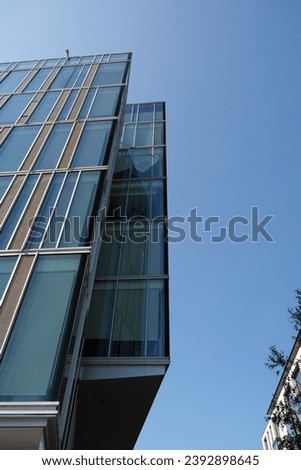 acute angle of glass office building Royalty-Free Stock Photo #2392898645