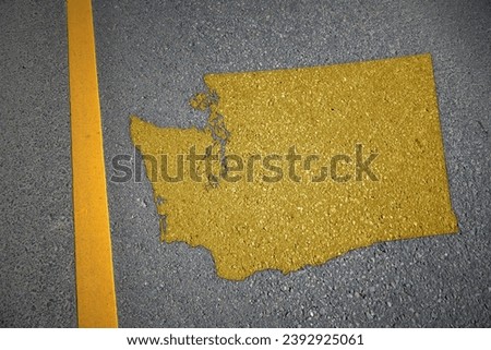 yellow map of washington state on asphalt road near yellow line. concept