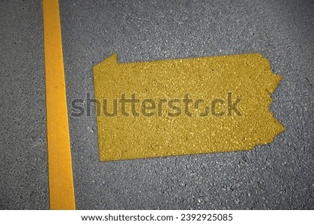 yellow map of pennsylvania state on asphalt road near yellow line. concept