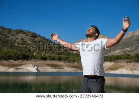 Adult Man Breathing Fresh Air in the Park or Forest. It can be used or mental health, inspiration, and well-being. Suitable for projects conveying messages of relaxation, stress reduction. Royalty-Free Stock Photo #2392940493