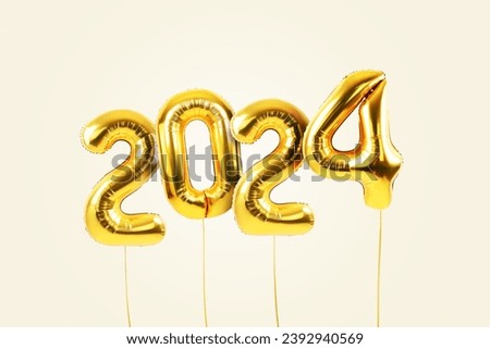 Happy new year 2024 metallic gold foil balloons flying on a beige background. Golden helium balloons number 2024 New Year. 