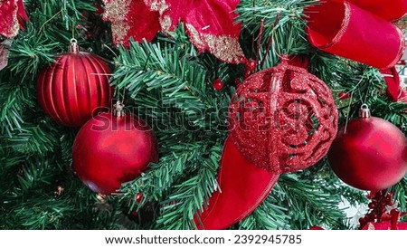 Christmas tree branches, green, Christmas ornaments decorated with balls and red bows with gold details.