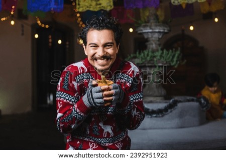 Latin man at traditional posada party for Christmas celebration in Mexico Latin America, holidays and Christmas eve