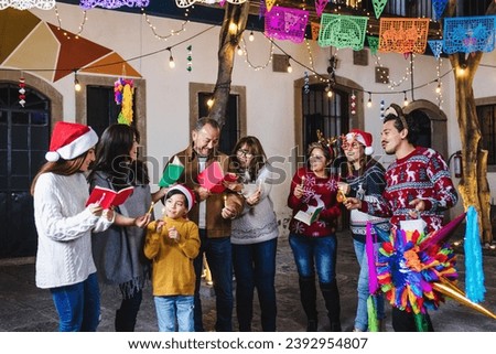 Latin family celebrating Mexican Posadas and Singing carols in Christmas eve in Mexico Latin America, hispanic culture and traditions