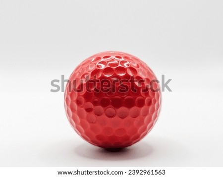 close up picture of red color golf ball with white background