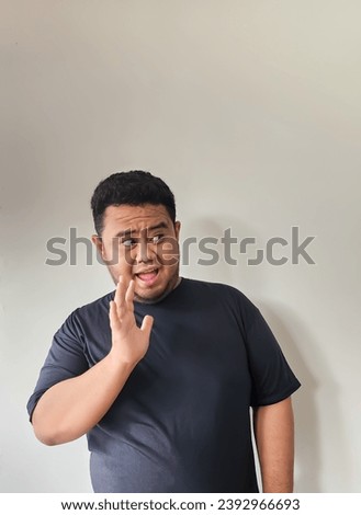 The expression of a fat Asian man was greeting someone with a funny face