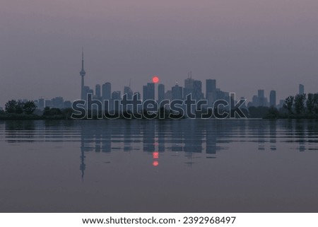 Red sunset over Toronto's skyline due to the wildfire pollution