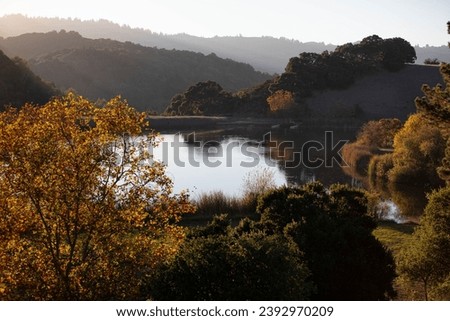 Boronda Lake at Foothills Nature Preserve, park and nature preserve in the Santa Cruz Mountains of California, in fall surrounded by beautiful landscape, fall foliage and hills, at sunset