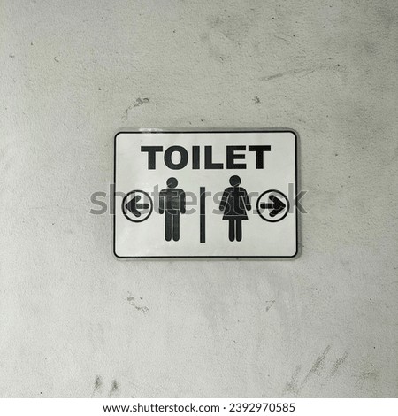 Toilet sign with white wall background
