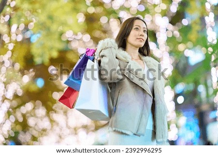 A woman carrying many shopping bags