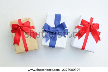 Stack of vintage or handmade gift boxes with blue,red ribbon bow isolate on a white backdrop.
