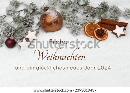 Christmas card: Brown Christmas balls with fir branches and Christmas decorations on a blanket of snow. German inscription reads Merry Christmas and a Happy New Year 2024. Royalty-Free Stock Photo #2393019437