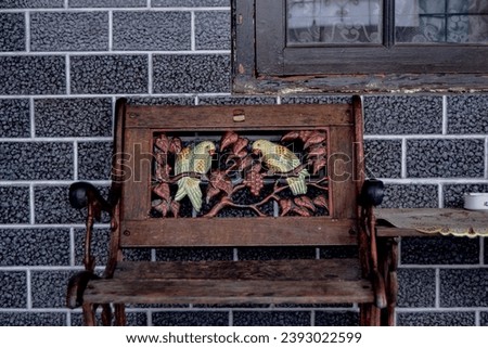 Antique Garden Chairs with a combination of wood and iron, there are tables glazed wall tiles and window that have an vintage design.