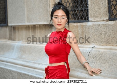 High-quality, free stock photo A fashionable Asian Vietnamese girl wearing a red dress is walking down the street, representing the energetic youth. Advertisements for products