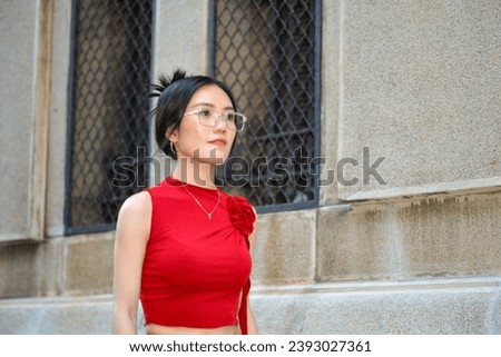 High-quality, free stock photo A fashionable Asian Vietnamese girl wearing a red dress is walking down the street, representing the energetic youth. Advertisements for products