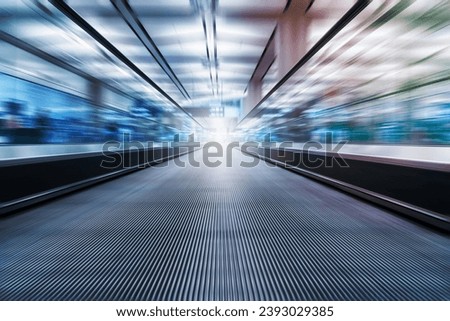 escalator motion blur in airport terminal Royalty-Free Stock Photo #2393029385