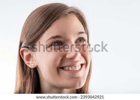 Young female's cheerful countenance and bright smile illuminate her light-hearted spirit Royalty-Free Stock Photo #2393042921