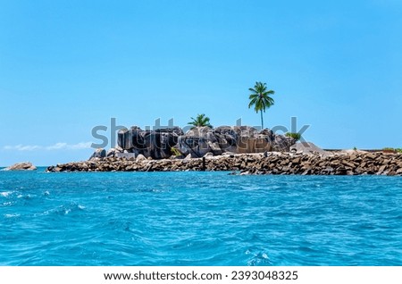 Granite rocks, Island Felicite, Republic of Seychelles, Africa. 
Granite rocks and palm trees on the Island Felicite, Indian ocean. Royalty-Free Stock Photo #2393048325