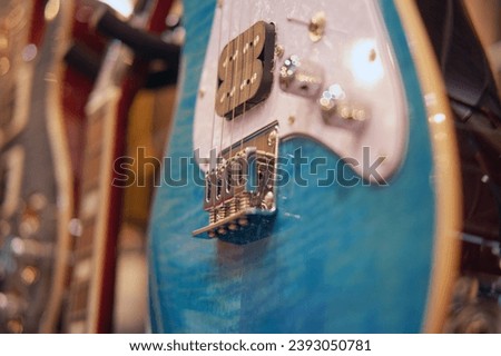 Electric guitar in a music shop, close-up. Blue guitar