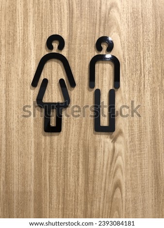 Man and Women toilet sign on wooden background