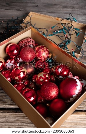 red Christmas decorations in a box